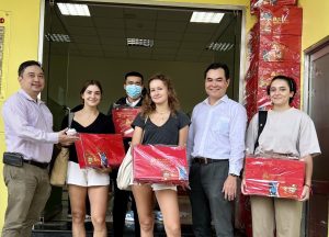 International students excitedly “show off” Tet gifts from Hoa Sen University